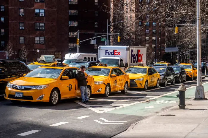 Yellow cabs double park in New York City.